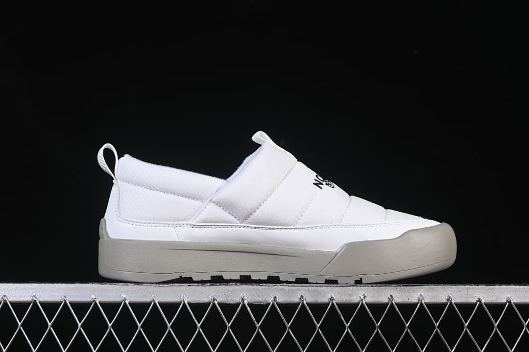 Side profile of a white slip-on shoe with grey outsole