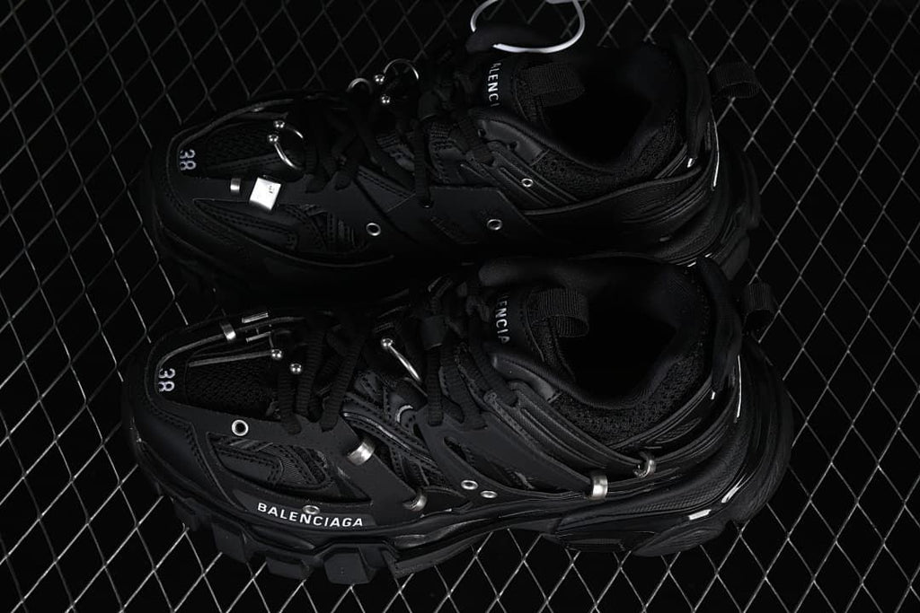 Pair of black Track Piercing sneakers viewed from above
