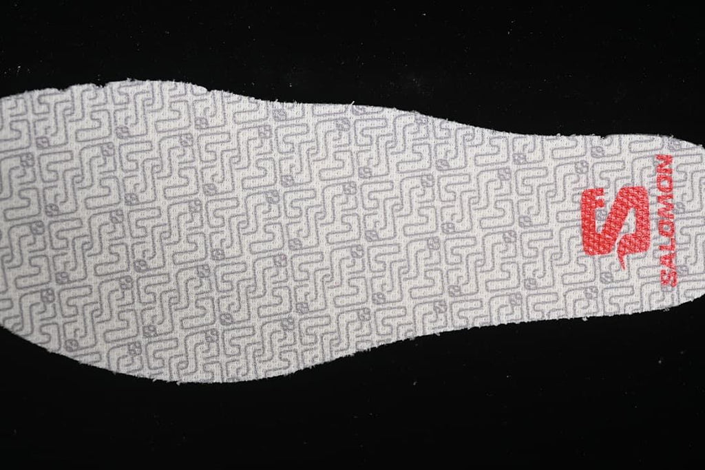 Close-up of a patterned insole with red Salomon branding.