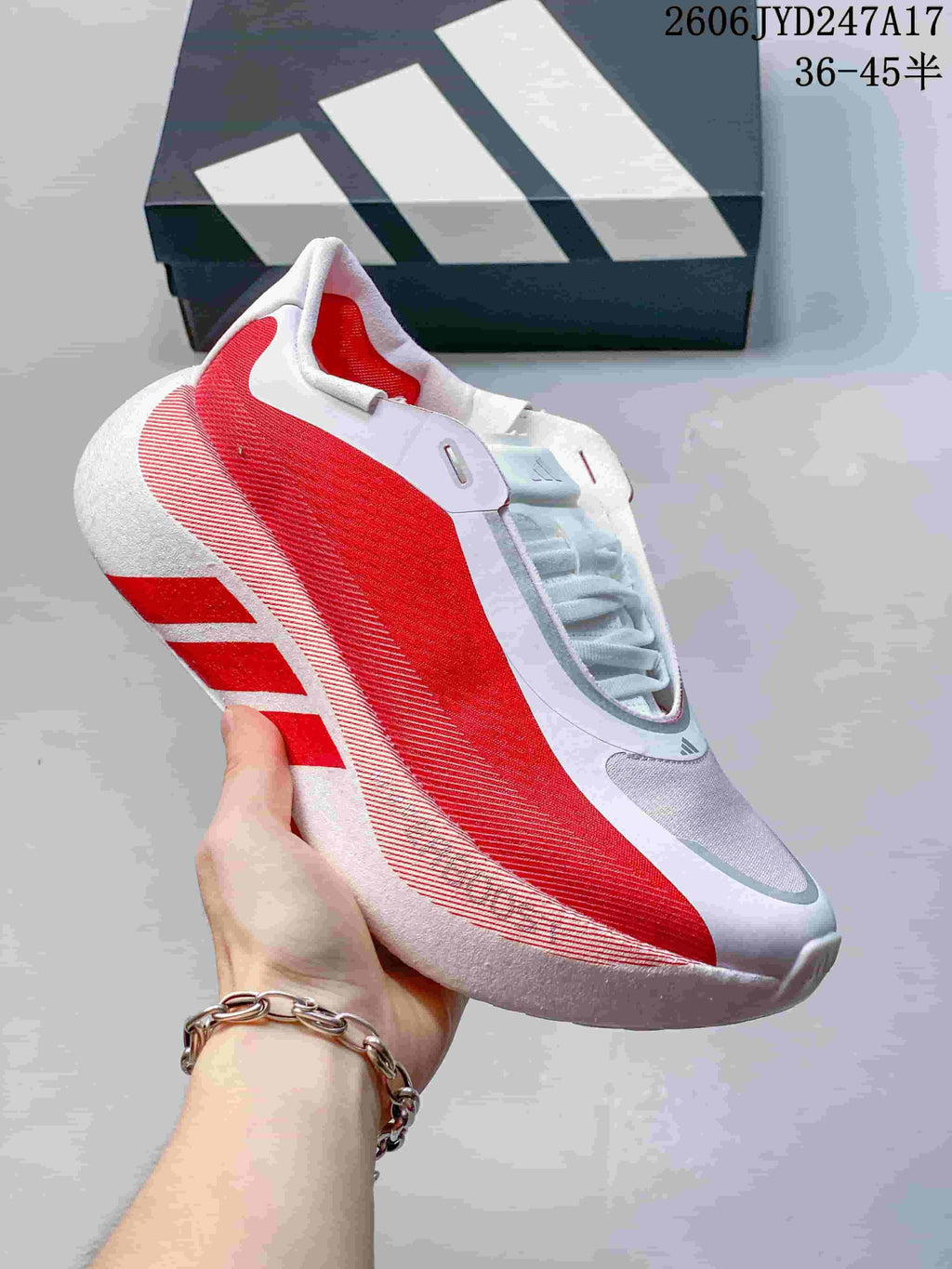 Dark gray Adidas HYPERBOOST EDGE M shoe with a white sole and striped side detailing.