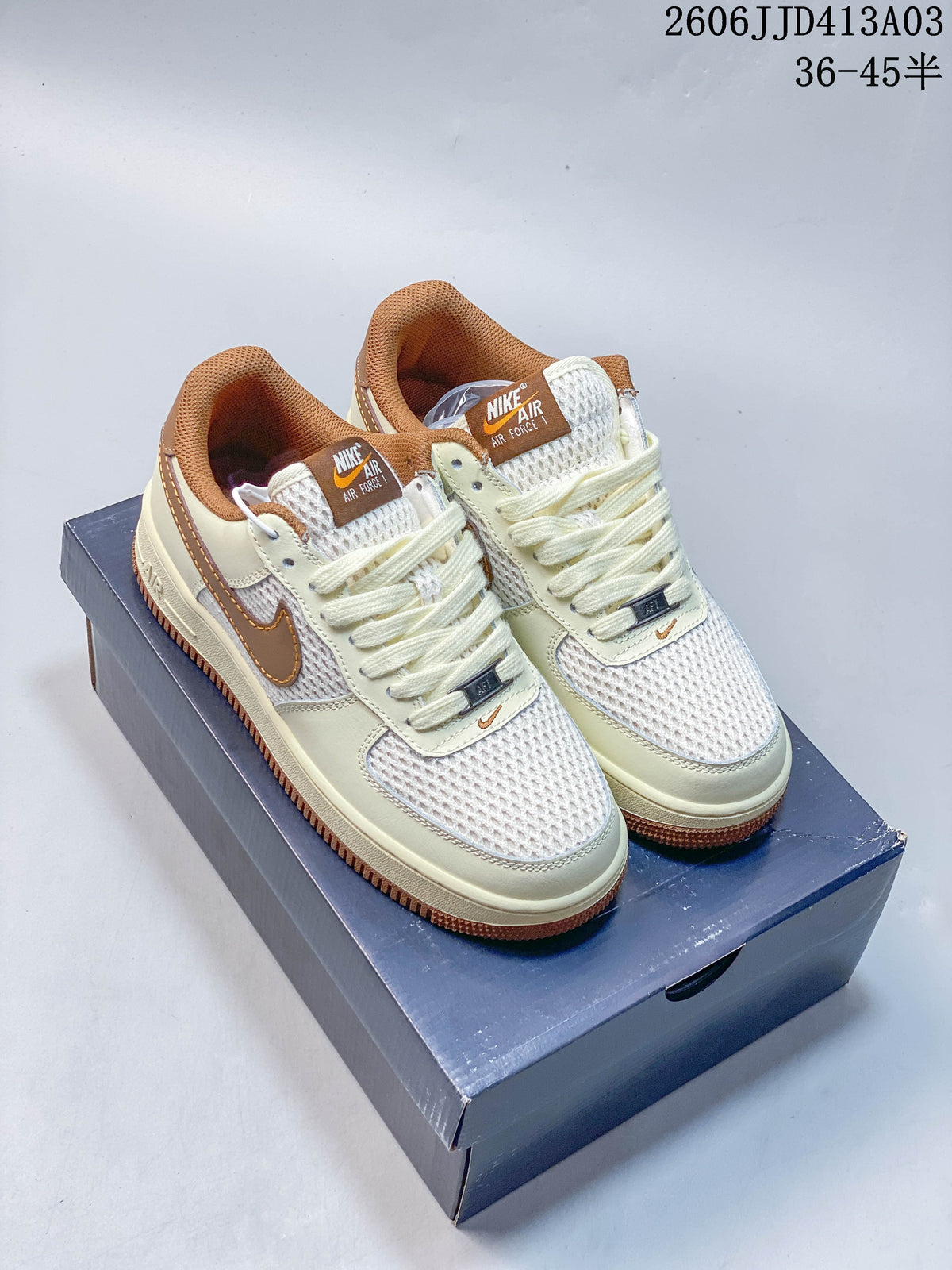 Pair of cream-and-brown low-top sneakers with mesh panels and gum-colored outsoles.