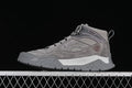 Side view of a gray Timberland mid-top shoe with patterned laces and a lugged sole