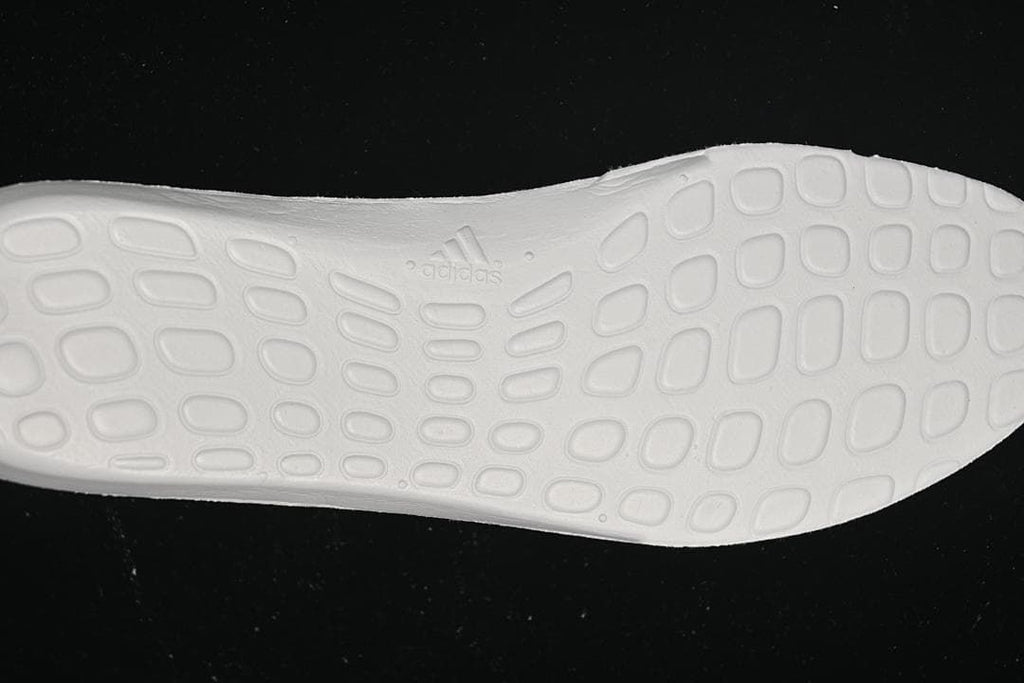 Close-up of the white outsole with molded Adidas branding.