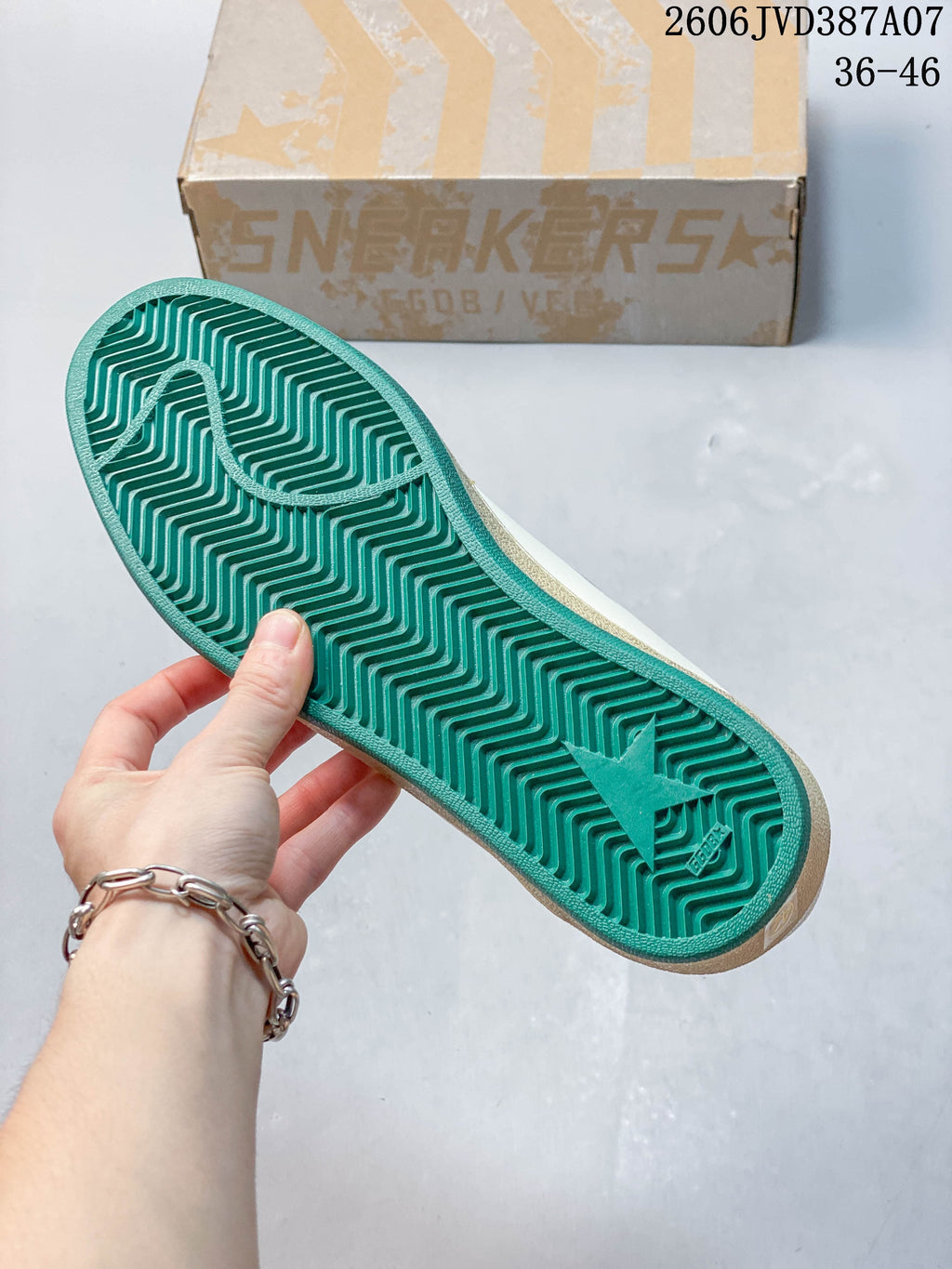 View of the sneaker's green patterned outsole.