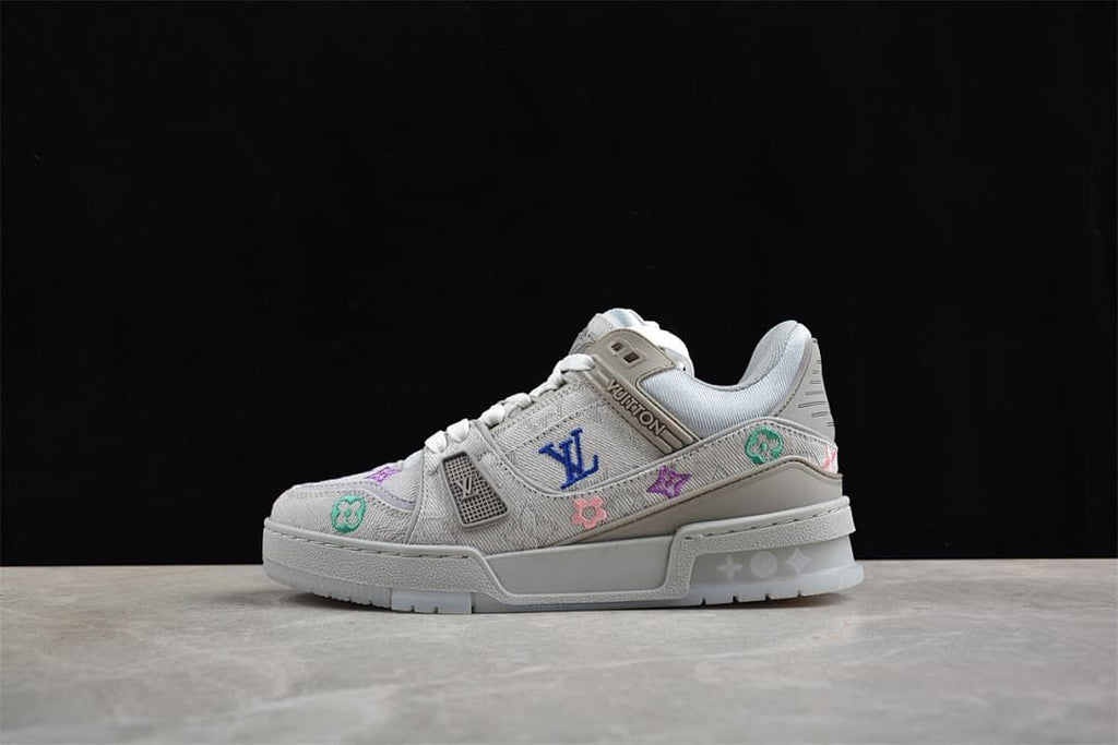 Side profile of a light gray sneaker against a dark background