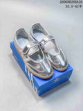 Pair of silver adidas Originals Samba Jane Mary Jane sneakers with gum-colored soles, shown on a blue shoebox.
