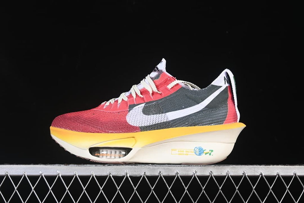 Side view of a red, dark green, white, and yellow Nike running shoe