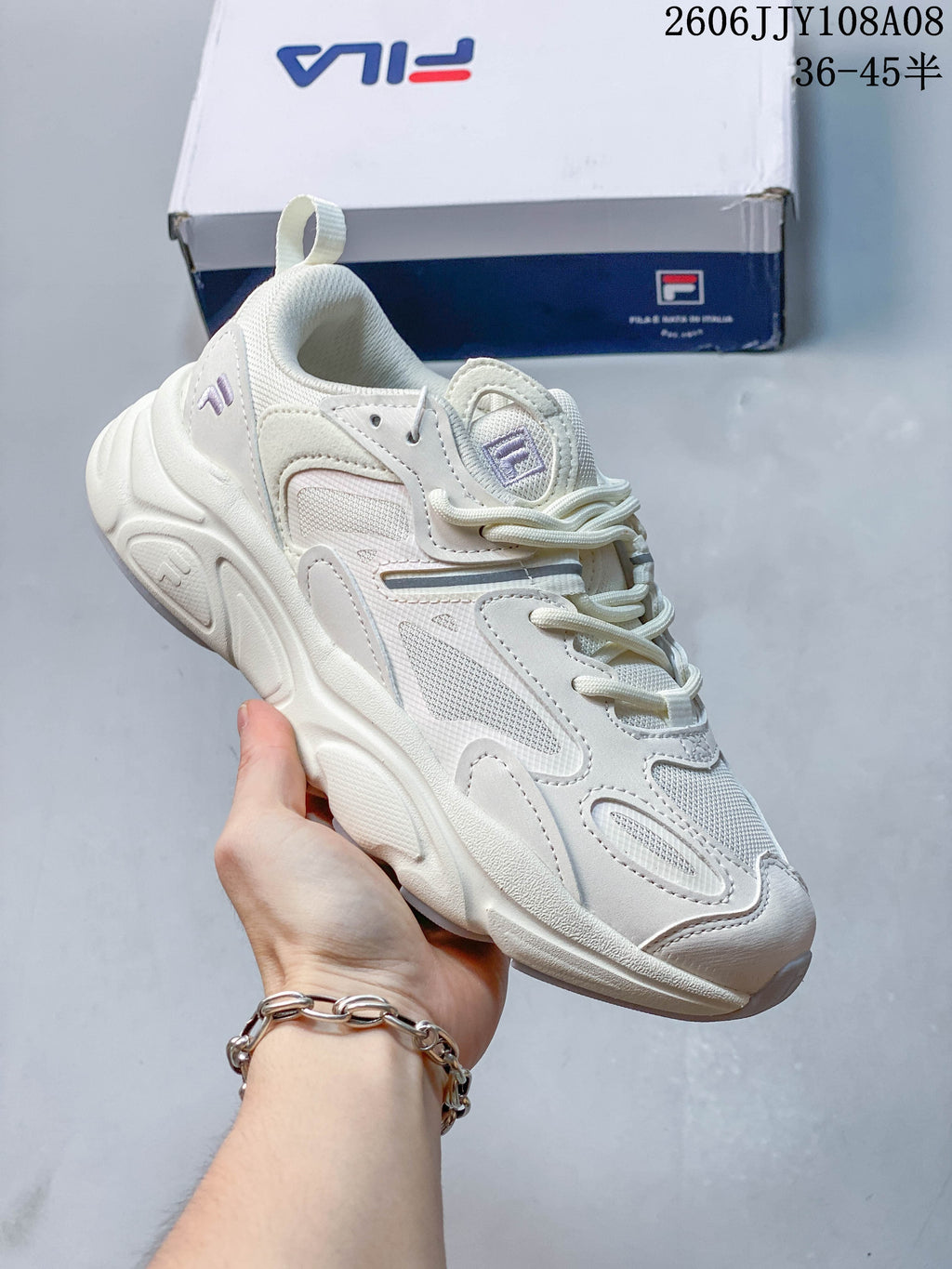 White FILA Fusion sneaker with mesh panels and a sculpted sole