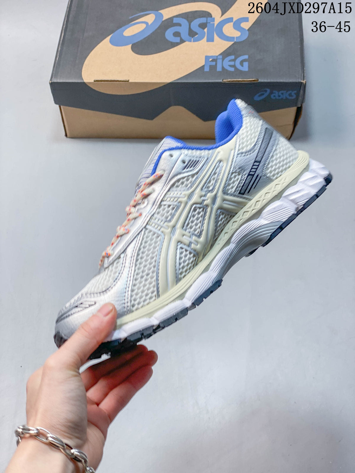 Side profile of the silver-toned sneaker with blue lining, layered panels, and a sculpted sole.