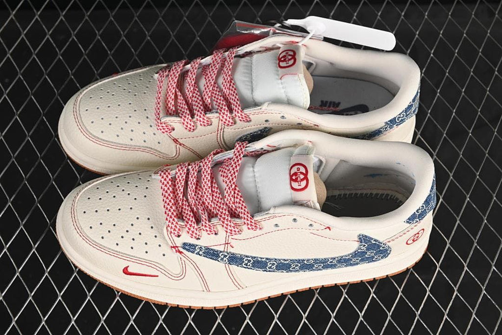 Overhead view of a pair of off-white low-top sneakers with perforated toe boxes, blue patterned panels, and red-and-white laces.