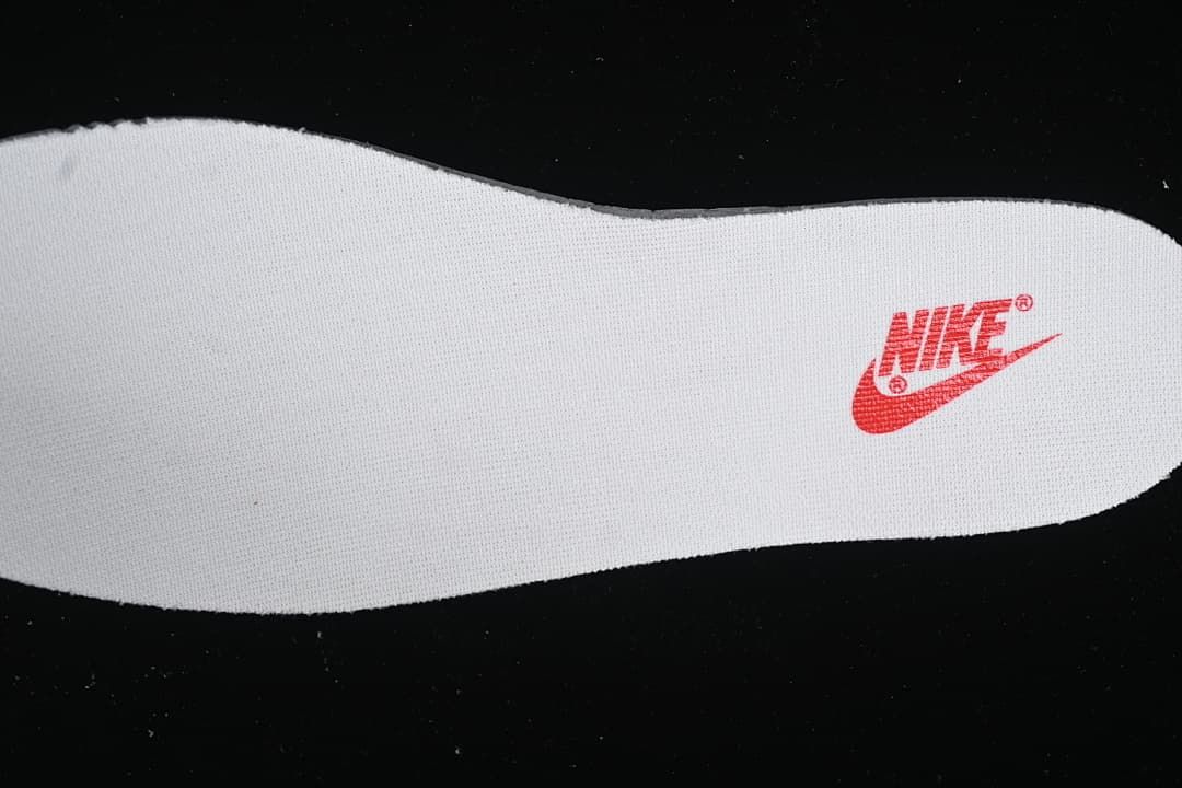 White shoe-shaped piece with a red Nike mark