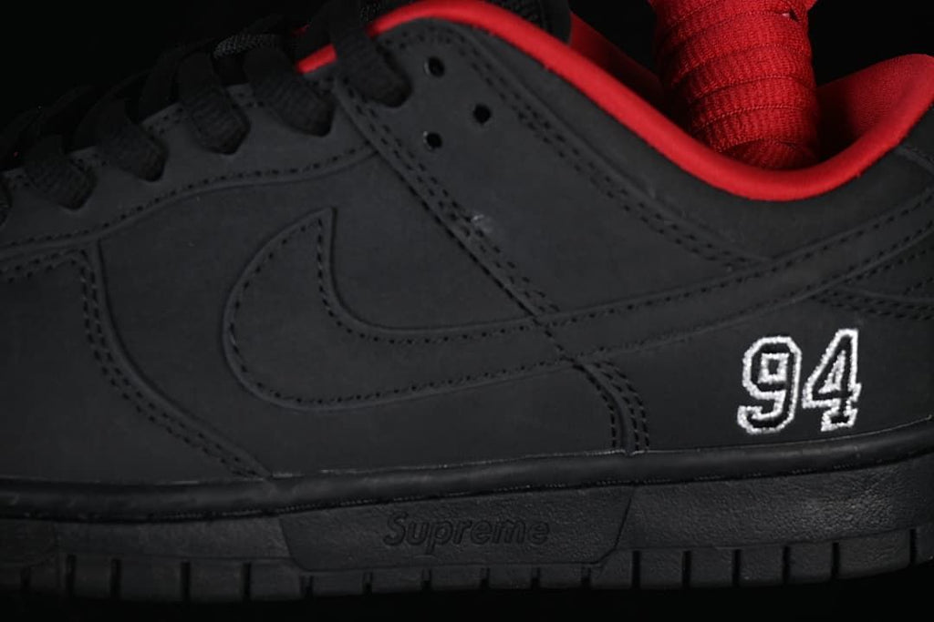 Close-up of the black side panel, Swoosh, and white 94 embroidery