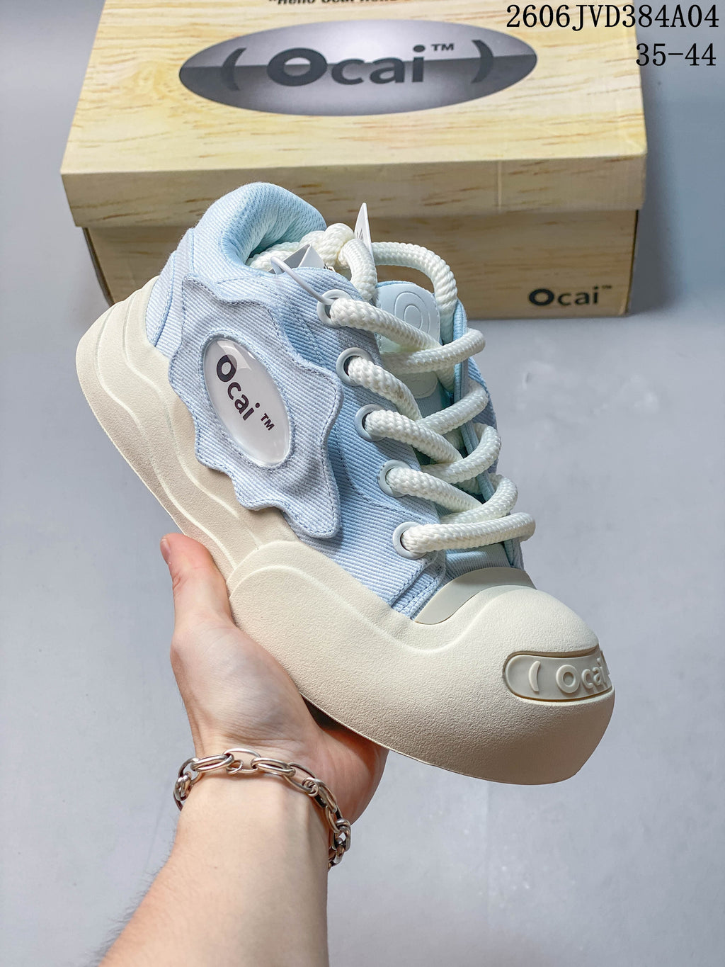 Pale blue Ocai sneaker shown with a branded box