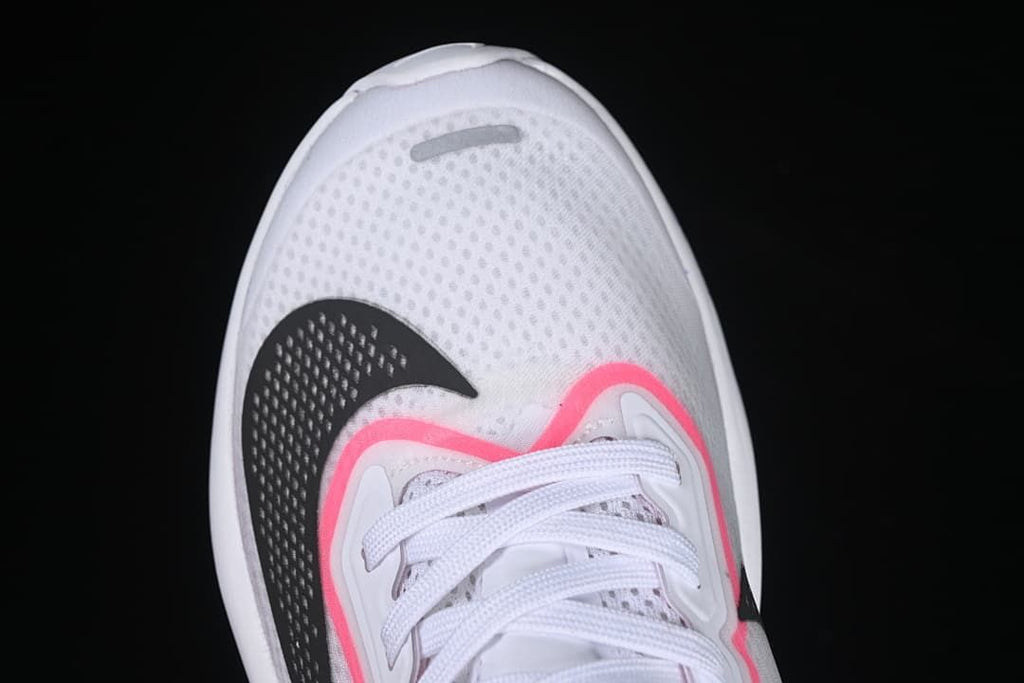 Close-up of perforated white toe area and black Swoosh