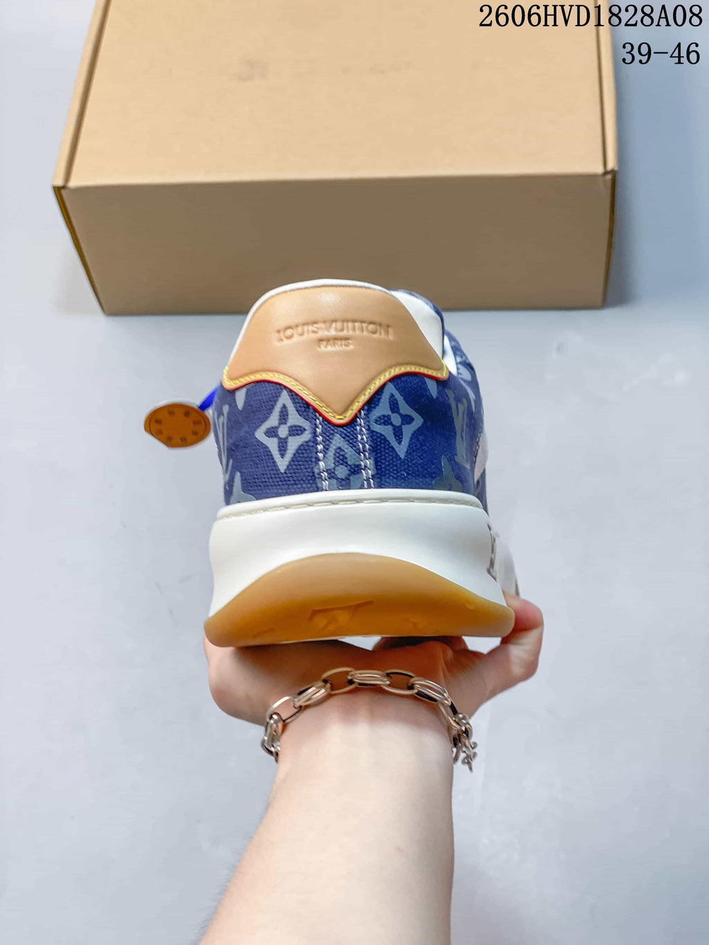 Rear view of the sneaker with blue patterned upper and tan heel detail