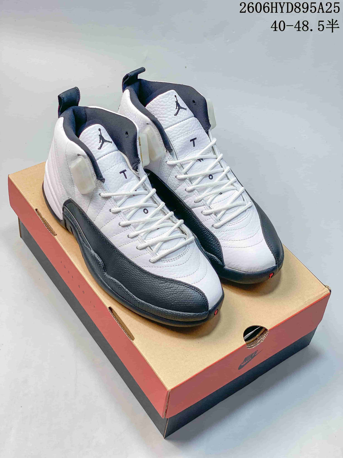White and black Jordan Air Jordan 12 high-top shoes displayed on a shoe box; image includes a printed size range.