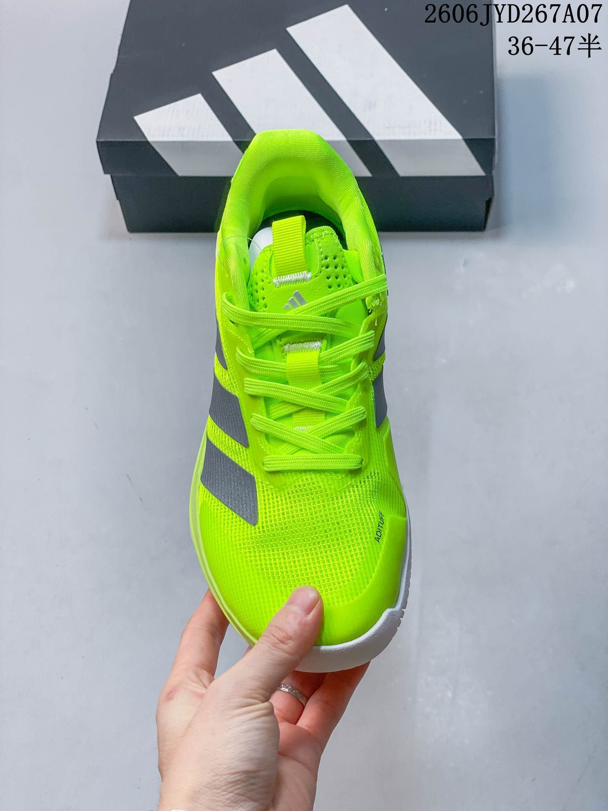 Front view of the bright yellow lace-up tennis shoe.