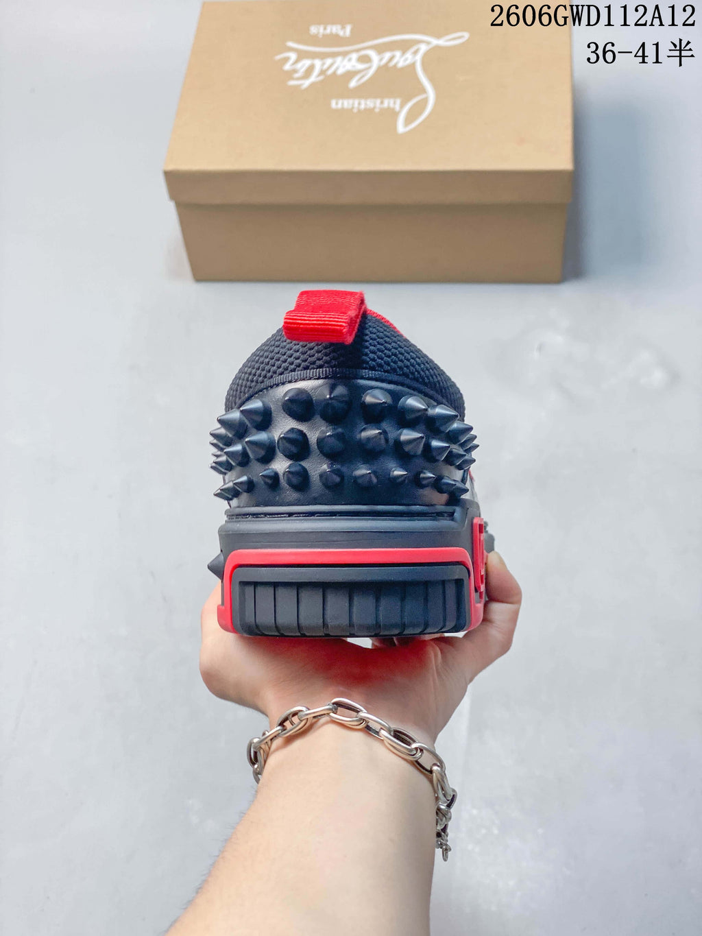 Rear view showing the sneaker's spiked heel detailing