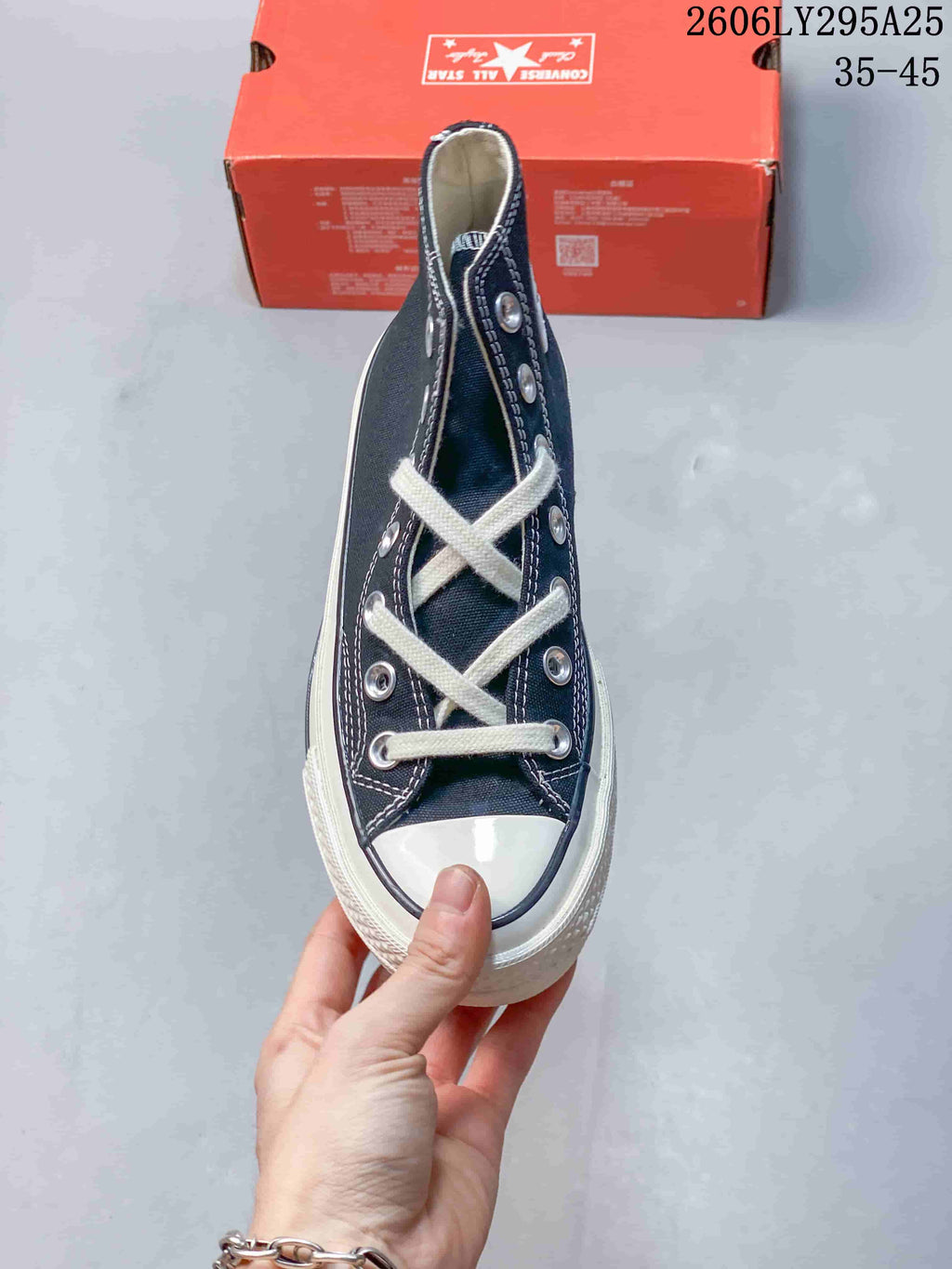 Top view of a navy high-top Converse sneaker with white laces