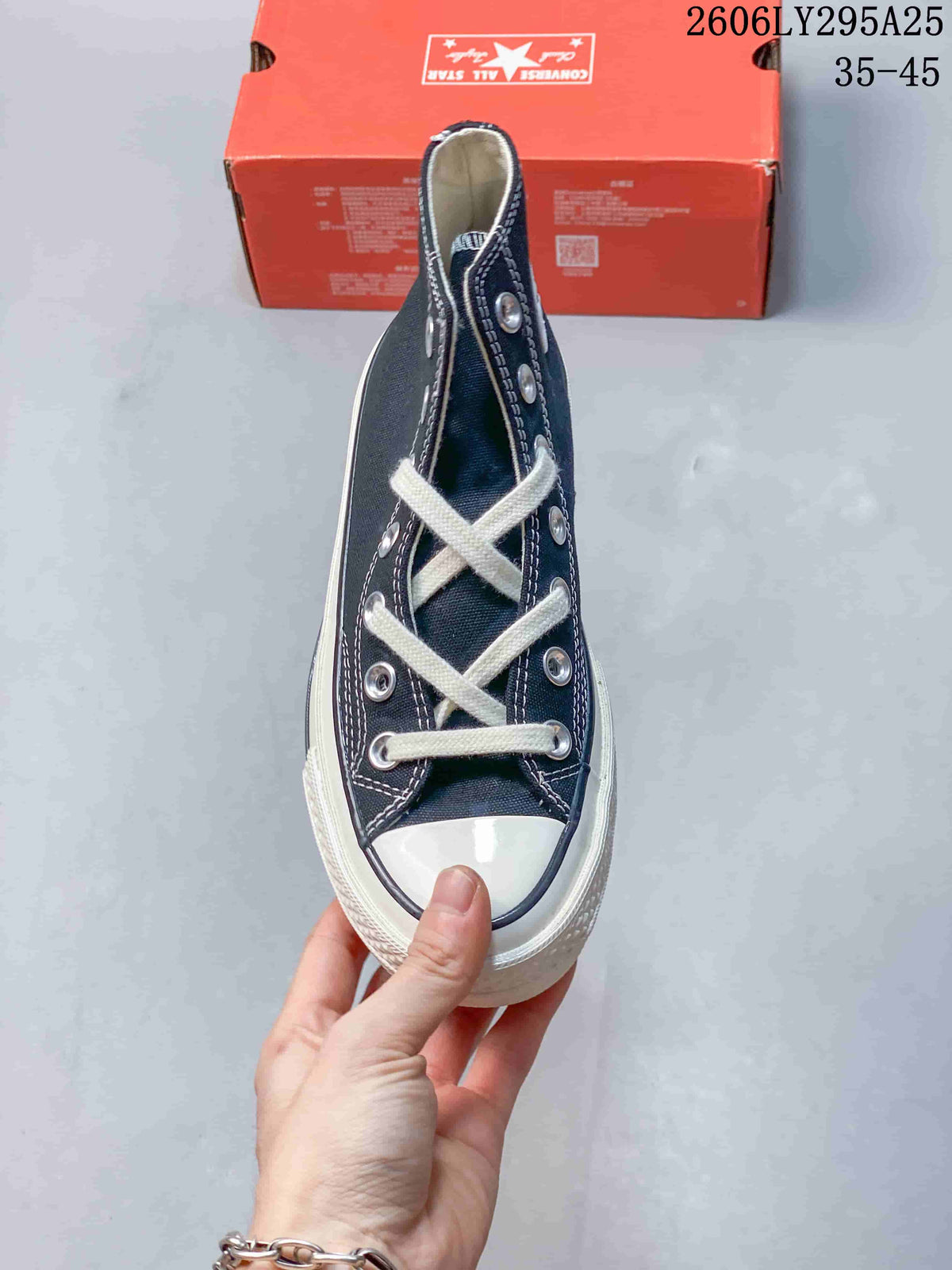 Top view of a navy high-top Converse sneaker with white laces
