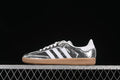 Side view of a silver patterned adidas Samba OG sneaker with white stripes and a gum-colored sole
