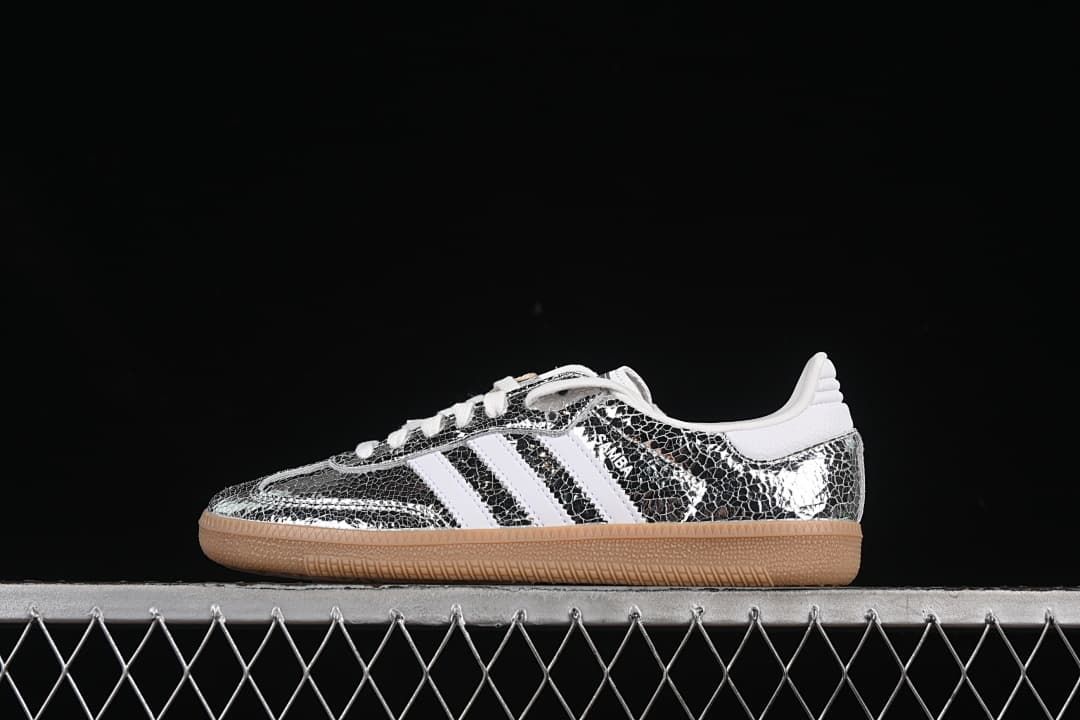Side view of a silver patterned adidas Samba OG sneaker with white stripes and a gum-colored sole