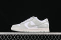 Side view of a white and light grey low-top Nike SB Dunk sneaker