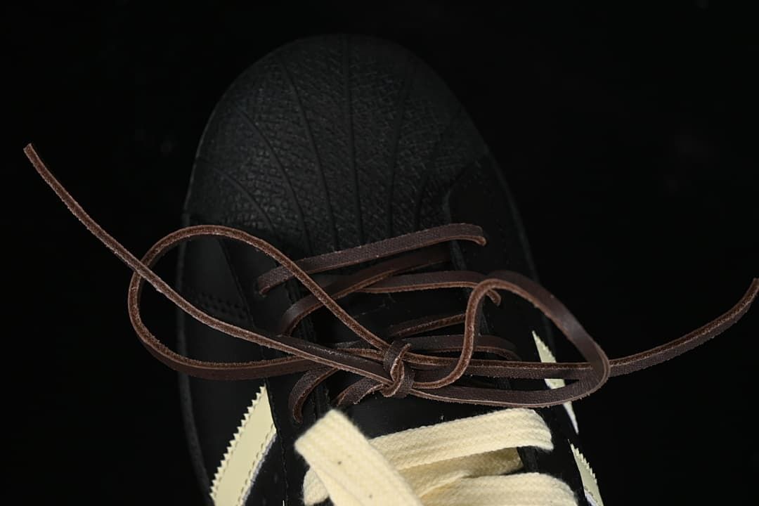 Top view of brown and cream laces over the textured shell toe.