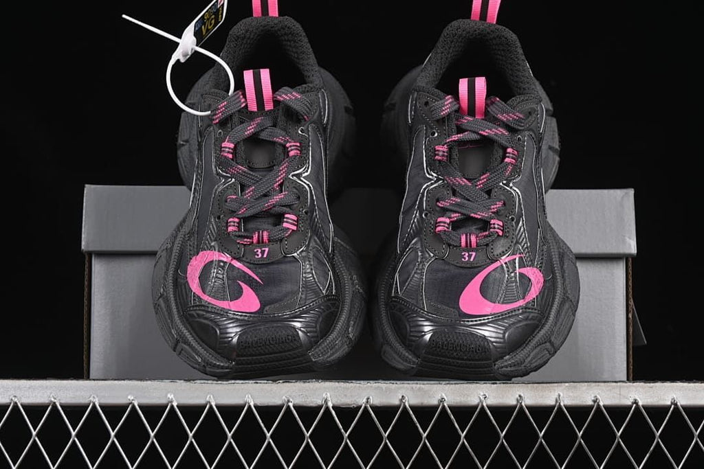 Front view of the pair showing pink details and chunky soles.