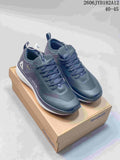 Pair of dark gray Reebok low-top sneakers displayed on a Reebok Classic box