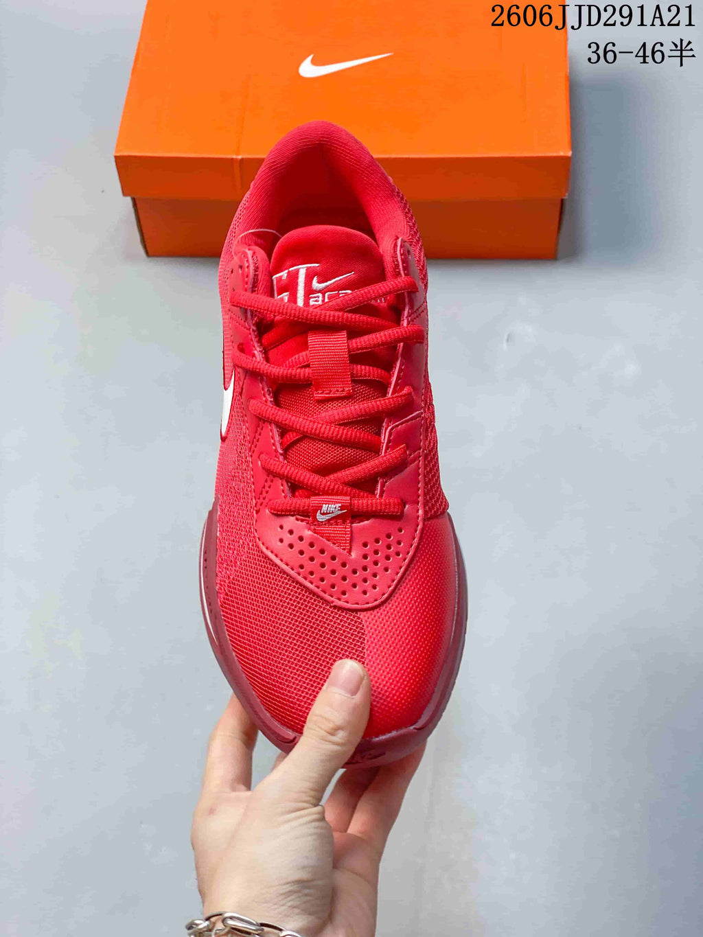 Top view of the red basketball shoe showing its laces and perforated overlay.