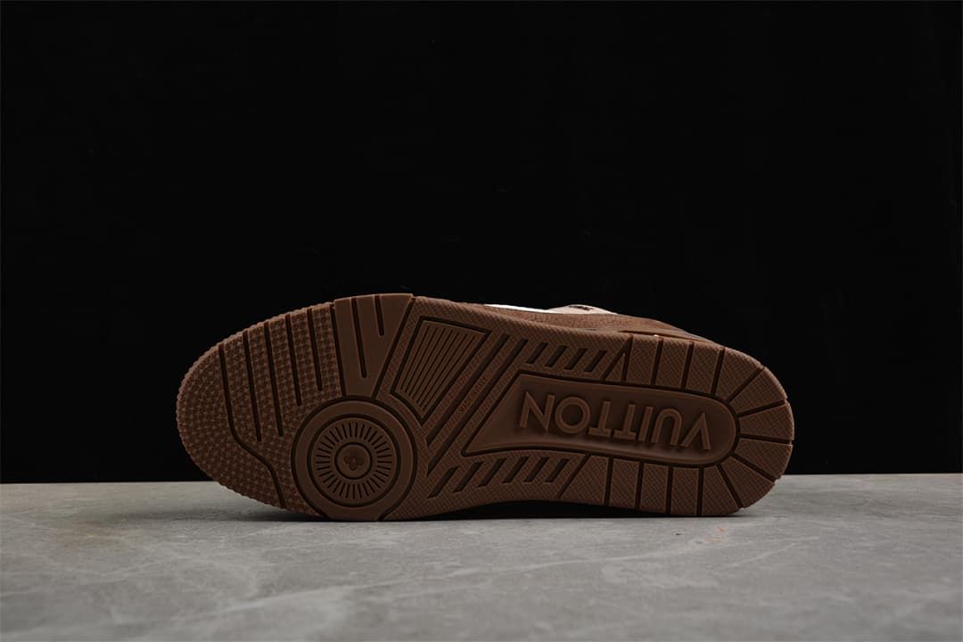 Underside view of the brown outsole with patterned tread.
