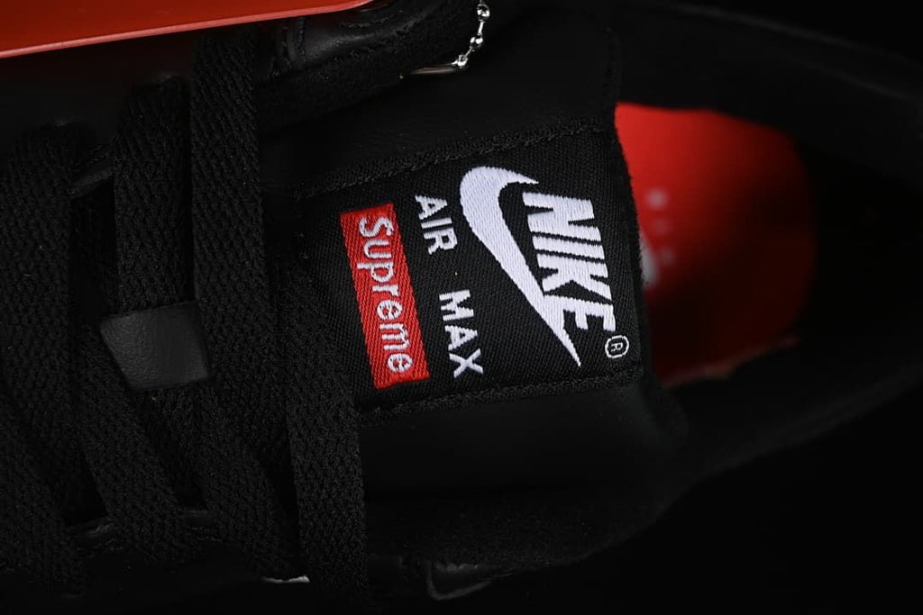 Close-up of the tongue label with Nike Air Max and Supreme graphics