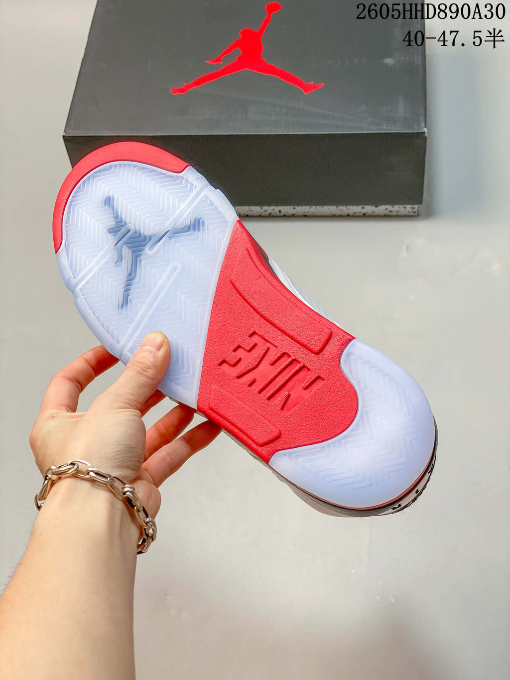 Close view of the sneaker outsole with translucent sections and a red center