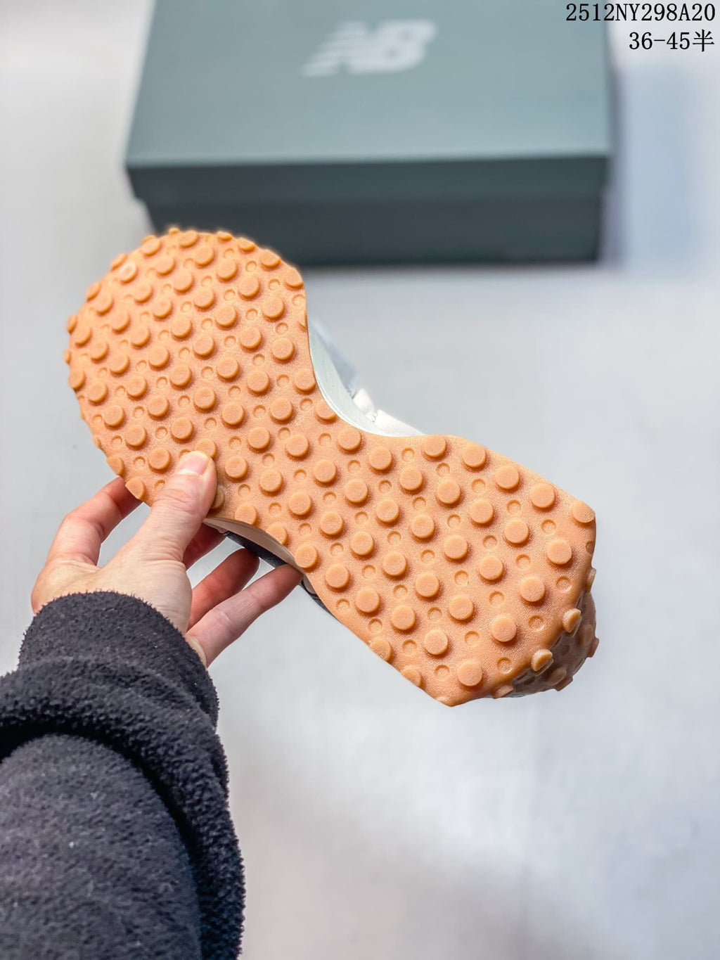 Close-up of the gum-colored outsole with a studded tread pattern.