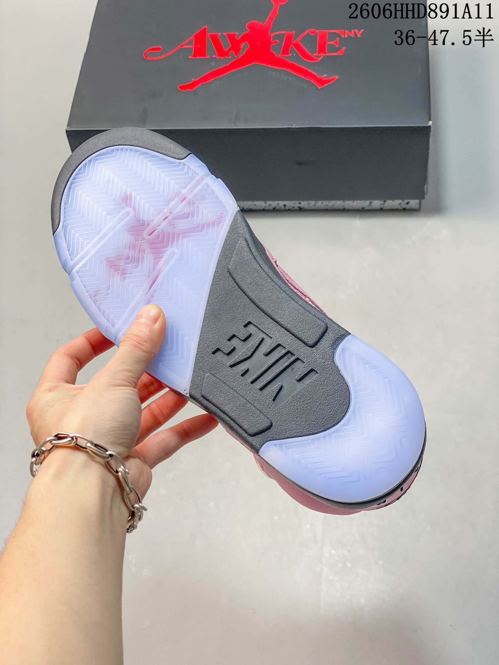 Underside of a sneaker showing a translucent-looking outsole with a dark center section.