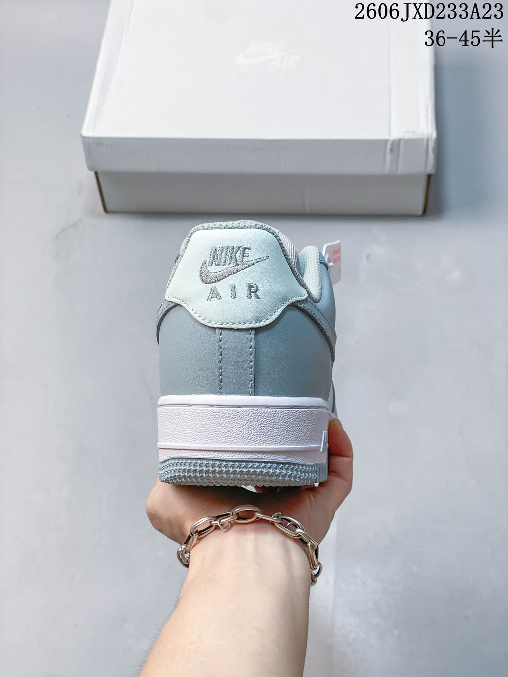 Rear view of a pale blue and white low-top sneaker