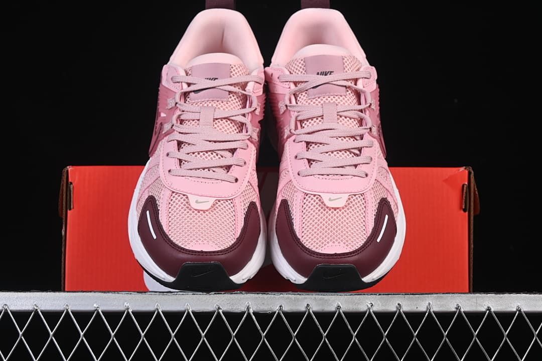 Front view of the pair with pink mesh uppers and burgundy toe panels