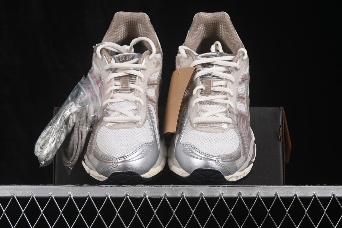 Front view of the pair showing the rounded toe boxes, white laces, padded collars, and silver-gray accents.