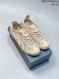 Pair of cream Onitsuka Tiger Mexico 66 low-top sneakers with patterned panels, shown on a branded shoe box