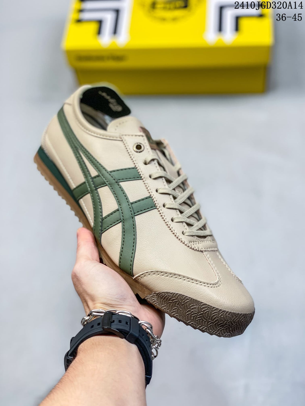 Cream low-top sneaker with green side stripes and brown outsole accents