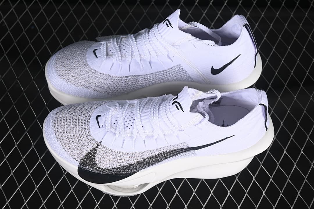 Pair of white and black running shoes shown from above and the side