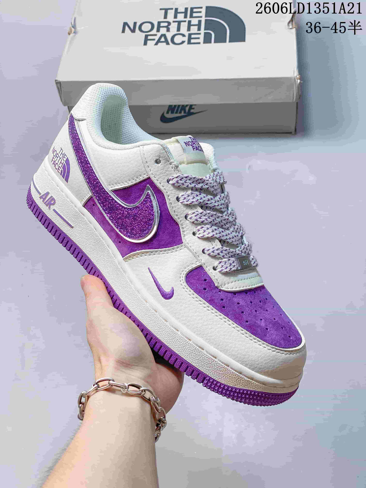 White low-top sneaker with purple glitter Swoosh and bright violet accents