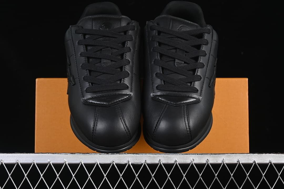 Front view of the pair of black lace-up sneakers