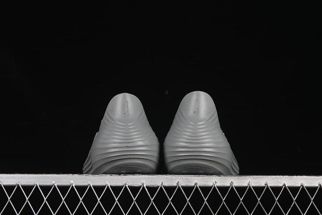 Rear view of a pair of grey clog sandals