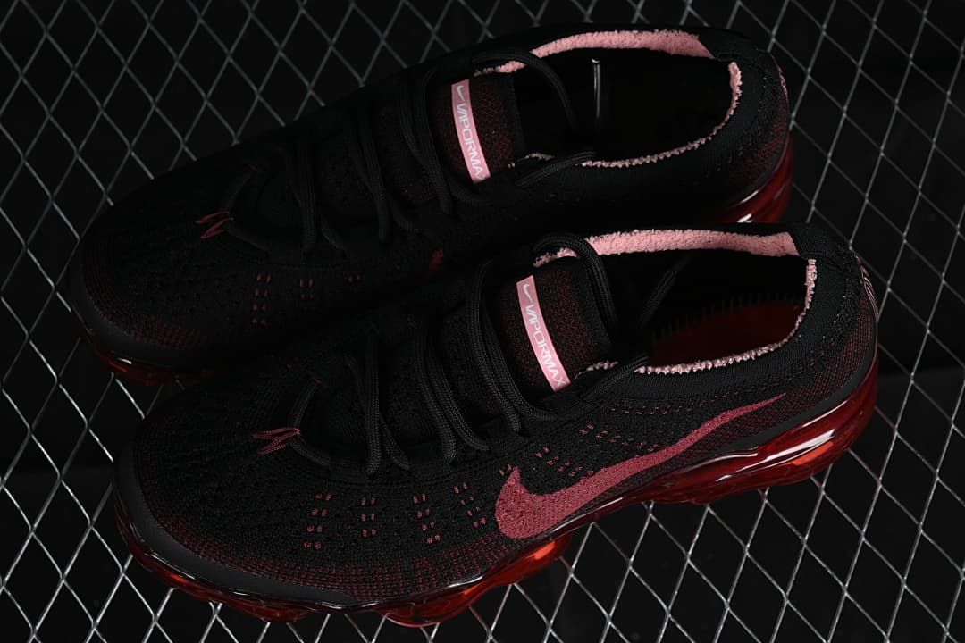 Pair of black and dark red Nike VaporMax sneakers shown from above