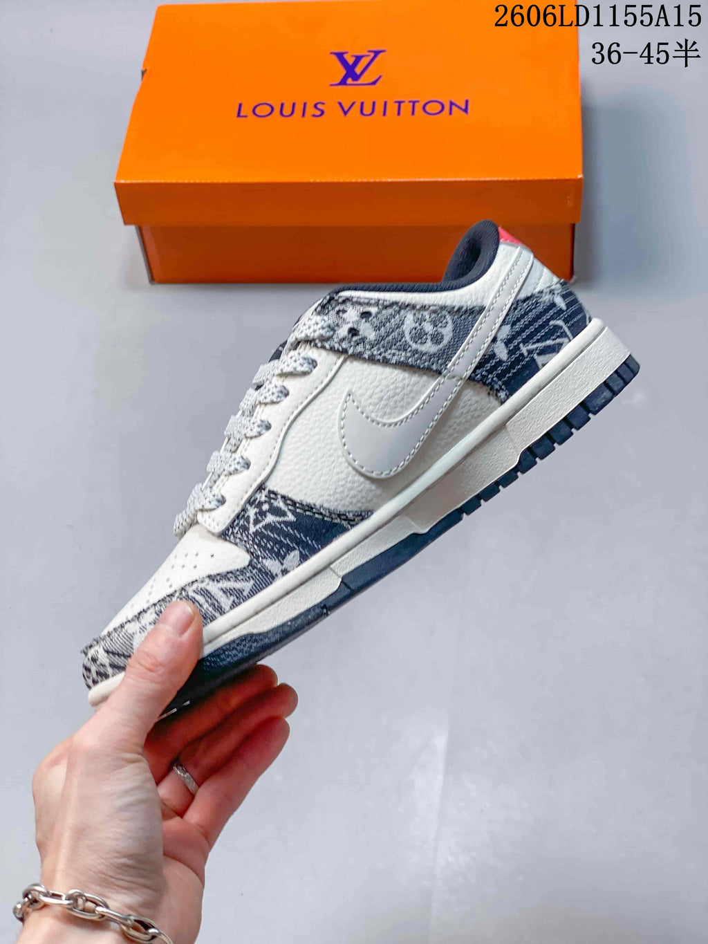 Side view of a white low-top sneaker with a dark patterned design and swoosh