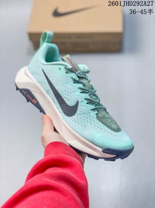 Mint-colored Nike trail running shoe with a dark Swoosh, white midsole, and dark outsole.