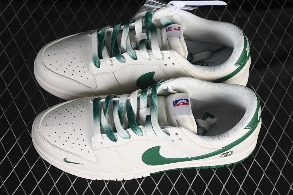Top view of a pair of white and green Nike SB Dunk Low sneakers with mixed-color laces