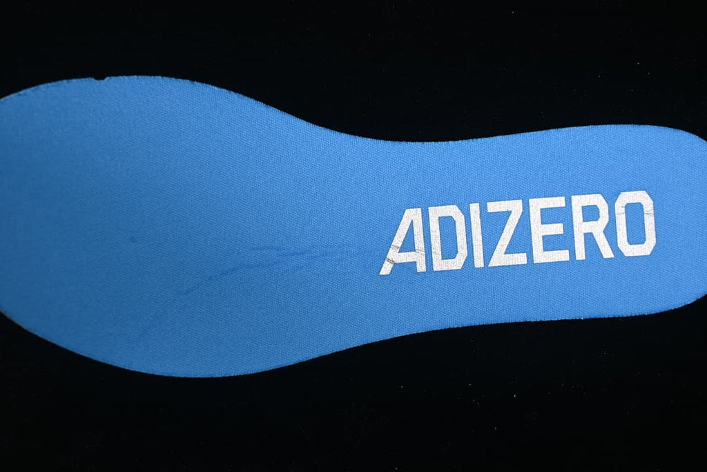 Blue insole with Adizero lettering.